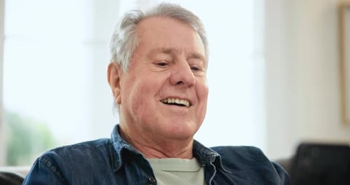 Senior Man Using Smartphone at Home