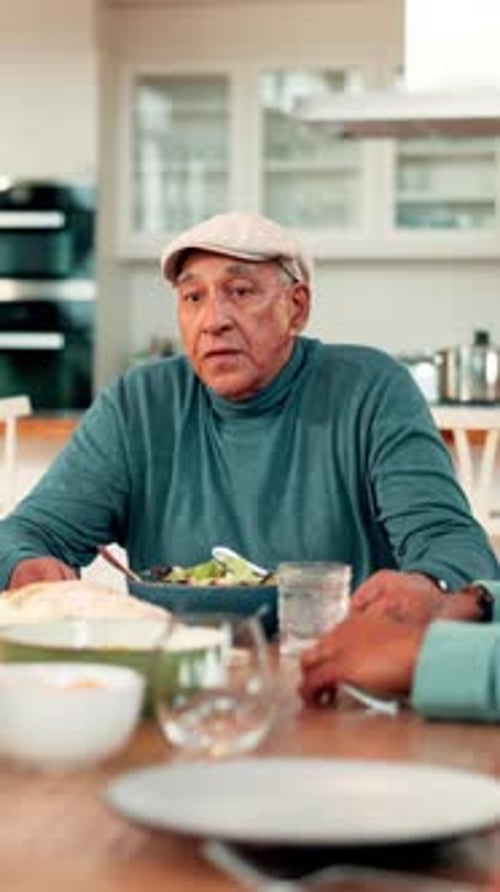 Senior Man Sitting at Table Talking to Companion