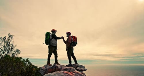 Mature man, friends and mountain hiking with high five on cliff for teamwork