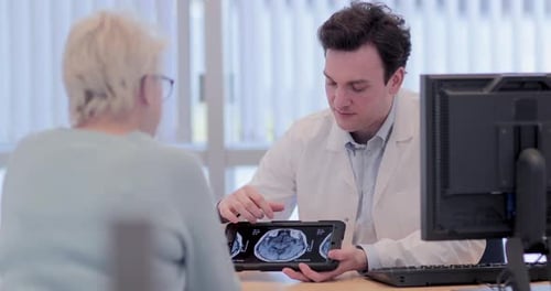 Doctor Explains Brain Scan to Senior Patient