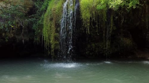Scenic nature of beautiful wild waterfall and emerald pool of fresh water lake in jungle forest