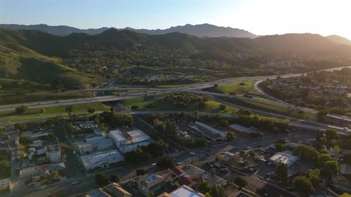 An Aerial View of a Los Angeles Suburb Featuring a Freeway Interchange at Sunset Sky