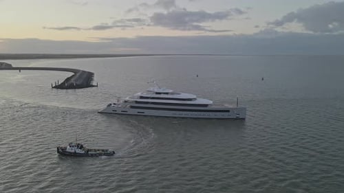 Aerial view of luxury super yacht leaving the harbour at sunrise, Netherlands