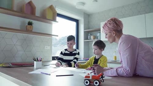 Mother and Children Drawing Together in Kitchen