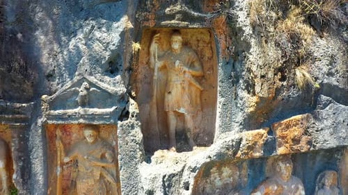 Ancient Stone Sculptures Carved into Mountain Wall