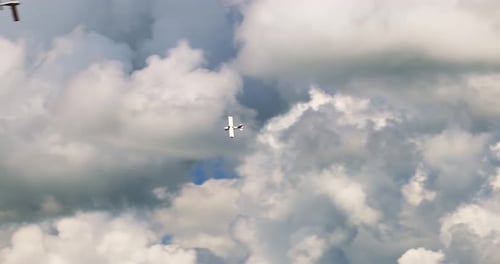 Airplanes Fly in Cloudy Blue Sky