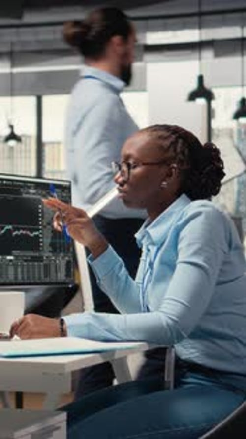 Vertical Video Financial Analyst in Prop Firm Office Doing Research on Stock Market Shares