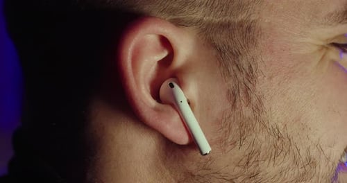 Putting Wireless Earbuds in Ear, Audio Listening Close-Up