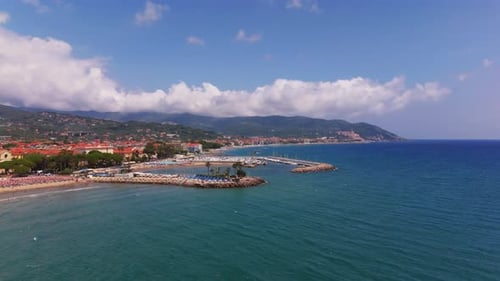 Rising Circular Aerial Shot Facing Marina and Coastal Town in Liguria