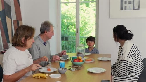 Family Eating Breakfast at Table in Bright Home