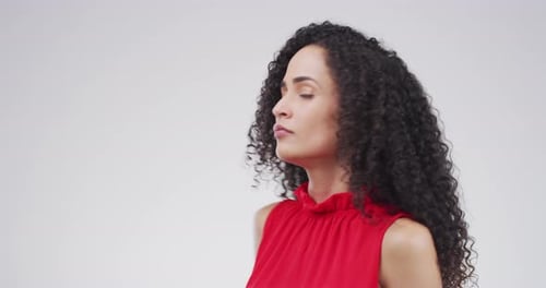 4k video footage of a stressed out young woman standing against a grey background