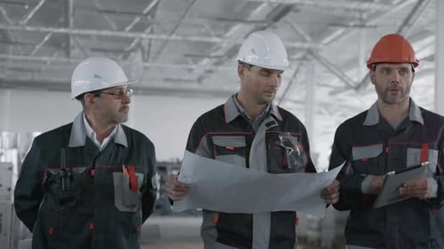 Engineer Planning Work at Machine Manufacture. Male Person in Hardhat or Protective