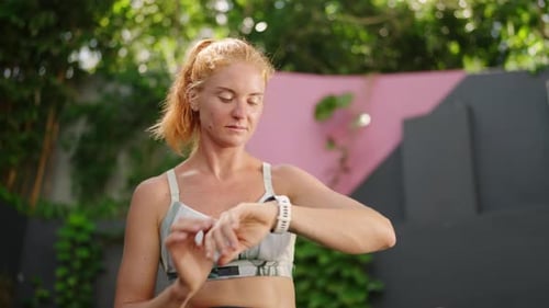 Redhead Female Athlete Checks Smart Watch in Luxury Tropical Gym Pro Uses Tracker During Workout