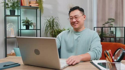 Man Working on Laptop in Home Office