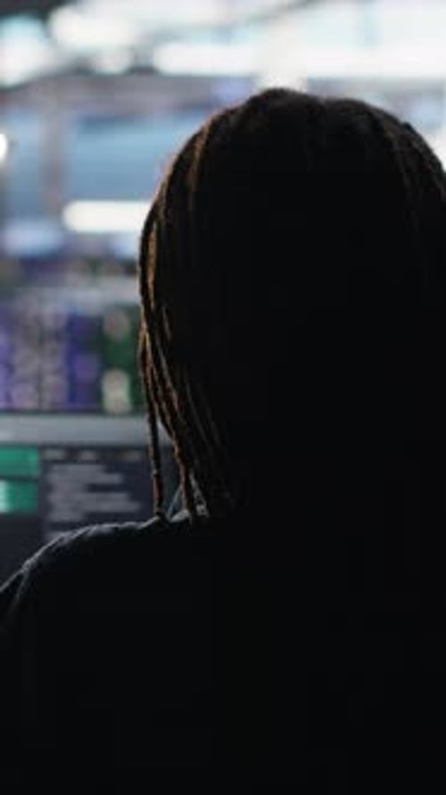 Vertical Video Data Center Engineer Using Algorithms to Analyze Datasets Putting on Headphones