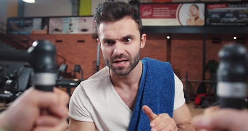 Confident Man with Towel at Gym