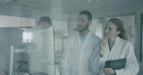 Scientists Discussing Research Results in Modern Laboratory