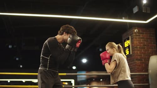 Smiling Sport Couple Boxing at Gym. Closeup Attractive Male and Female Boxers