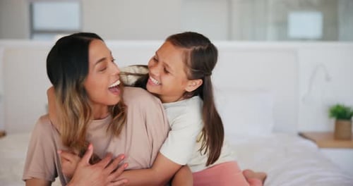 Loving Mother and Daughter Embrace in Bedroom