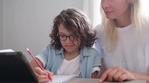 Mother and Small Son Eyeglasses Study Online on Laptop at Home Together Lesson Prepare Homework
