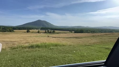 Cinematic View of the mountains from the car window while driving.Summer trip.