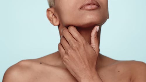 Woman Touching Neck in Beauty Shot