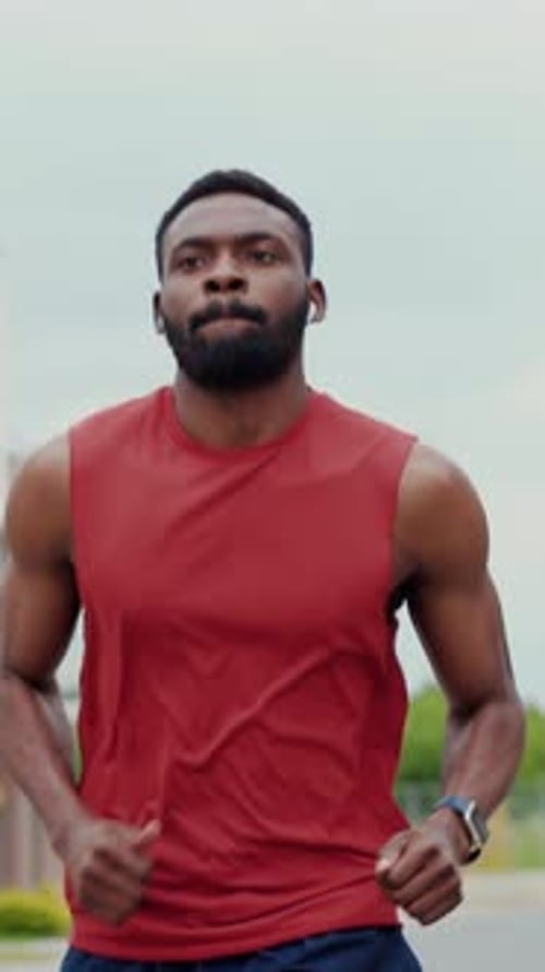 Athletic Man Jogging on Street in Urban Setting