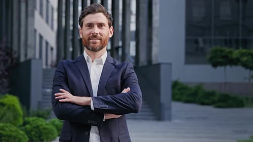 Successful Confident Businessman in Stylish Suit Standing on Background Office Building Smiling