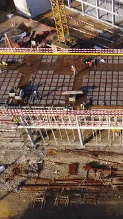 Vertical Video of Construction Workers in the Roof of New Building