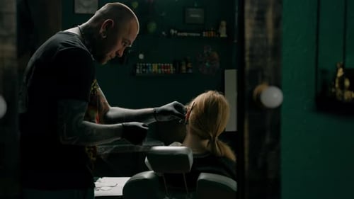 Piercing studio interior - piercing master makes a piercing to a girl, ear piercing