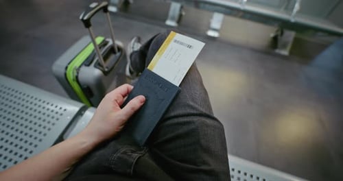 Airport Terminal Passenger with Suitcase Sitting in Departure Lounge of Airline Hub FirstPerson View