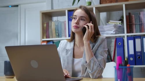 Portrait of Cheerful Office Girl Talking on Smartphone with a Friend Laughing During Break at Work