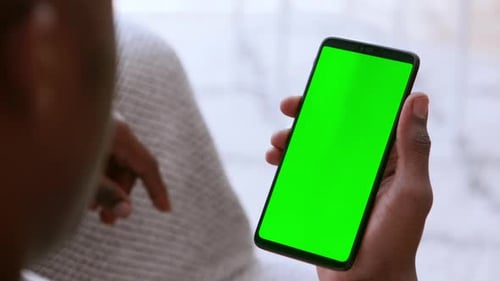 African Man Browsing on Cellphone with Chroma Key Screen