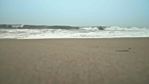 Ocean waves crashing into camera on beach in Dewey Beach, Delaware, Slow Motion