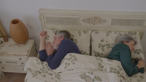 Senior Mature Couple Sleeping Peacefully in Bed