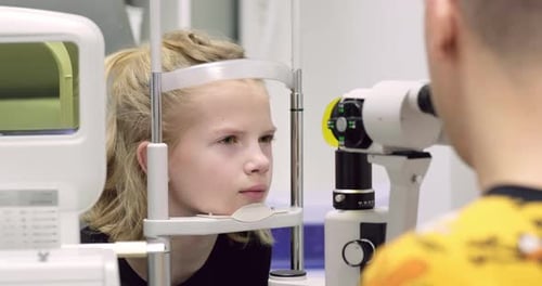 Doctor and Young Patient in Eye Clinic Girl Undergoing an Eye Test with Professional Optometrist