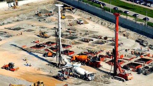 Busy Construction Site with Heavy Machinery Aerial View