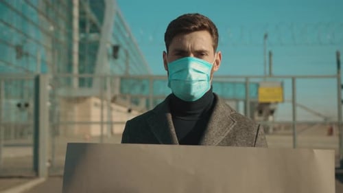 Close Up Man Wearing Protective Mask on Street Hold Poster From Pandemic to Social Distancing Look