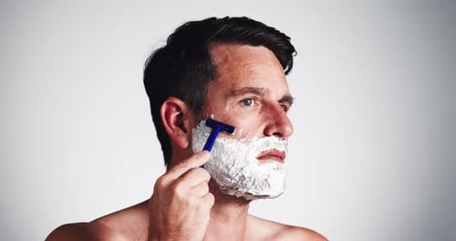Cream, razor and man in studio with shaving for self care, grooming or epilation treatment
