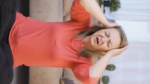 Woman Massaging Temples with Headache Pain