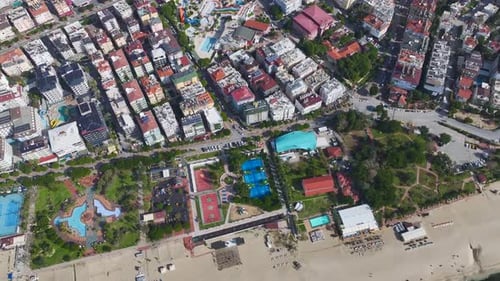 Aerial Video of a Scenic Park By the Sea With Tennis Courts Playgrounds Fountains and Tall Palm
