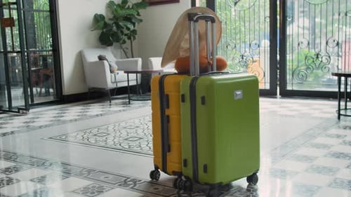 Colorful Suitcases, Straw Hat and Pillow in Hall of Elegant Hotel, No People