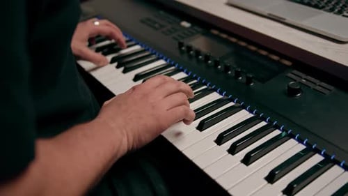 professional recording studio sound engineer or music producer musician pressing synthesizer keys