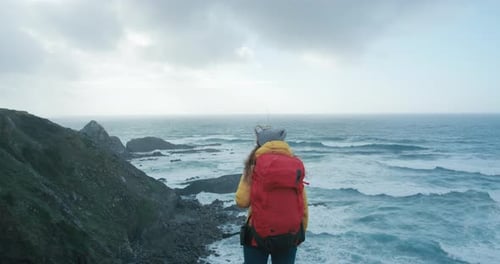 Female Hiker in Epic Cinematic Coast Scenery