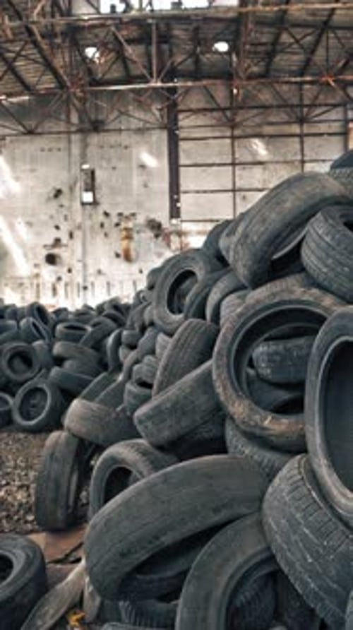 Old damaged tires after driving. Stack of car second used car rubber tires. Vertical video