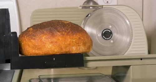 Loaf of Bread on a Bread Slicing Machine