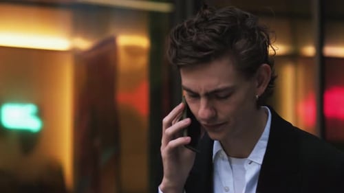 Young Adult in Distress on Phone in Urban Setting