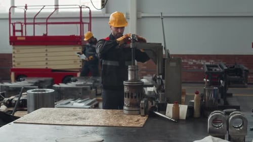 Industrial Workers Operating Machinery in Factory