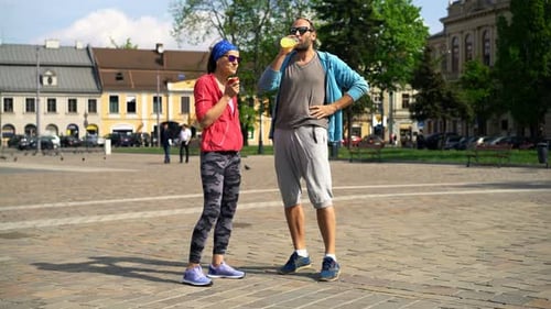 Man and woman chatting in city square