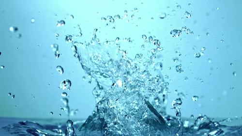 Closeup of a Water Drop on a Transparent Blue Surface